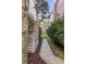 Landscaped walkway lined with lush greenery and a privacy fence, leading to a serene outdoor space at 3019 Viscount St, Charleston, SC 29424