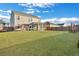 Expansive backyard featuring a lush lawn, screened porch, play set, and fencing for privacy and enjoyment at 302 Willow Pointe Cir, Summerville, SC 29486