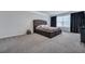 Luxurious bedroom with a tufted headboard, plush bedding, and soft gray carpet at 302 Willow Pointe Cir, Summerville, SC 29486