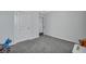 Neutral bedroom with gray carpet, white trim, and standard door leading to closet or hallway at 302 Willow Pointe Cir, Summerville, SC 29486