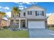 Charming home featuring a two-car garage, complemented by palm trees and meticulous landscaping at 302 Willow Pointe Cir, Summerville, SC 29486