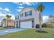 Inviting gray home with tidy landscaping, a spacious two-car garage, and a lush lawn at 302 Willow Pointe Cir, Summerville, SC 29486