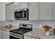 Modern kitchen features granite counters, tiled backsplash, and stainless steel appliances at 302 Willow Pointe Cir, Summerville, SC 29486