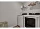 Modern laundry room with front load washer and dryer and wire shelving for efficient storage solutions at 302 Willow Pointe Cir, Summerville, SC 29486