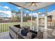 Inviting screened porch features comfortable seating and a ceiling fan for enjoying the outdoors at 302 Willow Pointe Cir, Summerville, SC 29486