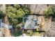 Aerial view of a home featuring a well-maintained roof, backyard deck, and driveway surrounded by lush trees at 3021 Rushland Mews, Johns Island, SC 29455