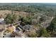Aerial view of a residential home with a large backyard, deck, and driveway nestled among trees at 3021 Rushland Mews, Johns Island, SC 29455