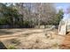 Large backyard with a wooden fence and mature trees, offering privacy and ample space for outdoor activities and relaxation at 3021 Rushland Mews, Johns Island, SC 29455
