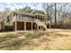 Back exterior of the house with a large backyard, two stories, and a balcony at 3021 Rushland Mews, Johns Island, SC 29455