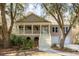 Charming two-story home featuring a welcoming front porch, landscaped yard, and attached two-car garage at 3021 Rushland Mews, Johns Island, SC 29455