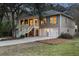 Charming two-story home featuring a welcoming staircase, a two-car garage, and manicured landscaping at dusk at 3021 Rushland Mews, Johns Island, SC 29455