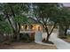 Charming two-story home featuring a welcoming staircase, covered porch, and manicured landscaping at dusk at 3021 Rushland Mews, Johns Island, SC 29455