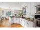 Bright kitchen with white cabinets, granite counters, hardwood floors, and an open layout at 3021 Rushland Mews, Johns Island, SC 29455