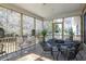 Screened porch with comfortable seating, a ceiling fan, and views of the lush greenery at 3021 Rushland Mews, Johns Island, SC 29455