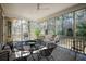 Cozy screened porch featuring a seating area, ceiling fan, and views of the surrounding woods at 3021 Rushland Mews, Johns Island, SC 29455