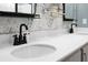 Modern bathroom showcasing stylish fixtures, a white vanity, and floral accent wall at 305 Lanyard St, Johns Island, SC 29455
