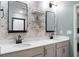 Bathroom featuring double sinks, modern fixtures, and stylish floral wallpaper at 305 Lanyard St, Johns Island, SC 29455