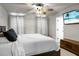 Cozy bedroom with a ceiling fan, light gray walls, and a modern television mounted on the wall at 305 Lanyard St, Johns Island, SC 29455