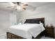 Well-lit bedroom with a ceiling fan, dark wood bed frame, and calming neutral wall color at 305 Lanyard St, Johns Island, SC 29455