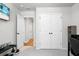 Bright bedroom featuring white closet doors, grey walls and carpet, and a TV with beach image at 305 Lanyard St, Johns Island, SC 29455