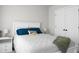 Bedroom featuring a white bed with blue pillows, a nightstand, and white closet doors with black handles at 305 Lanyard St, Johns Island, SC 29455