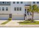 Beautiful townhome showing two-car garage, stairs leading to covered entrance, and manicured lawn at 305 Lanyard St, Johns Island, SC 29455