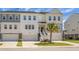 Inviting townhome featuring two-car garage, and welcoming front yard with a palm tree at 305 Lanyard St, Johns Island, SC 29455