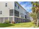 Townhome exterior featuring screened in decks, green space, and mature landscaping at 305 Lanyard St, Johns Island, SC 29455