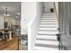 Bright foyer with staircase leading to upper level, adjacent to the open kitchen area at 305 Lanyard St, Johns Island, SC 29455