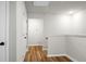 Second floor hallway featuring neutral paint, white trim, and wood flooring at 305 Lanyard St, Johns Island, SC 29455