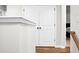 Upstairs hallway featuring white trim, wood flooring, and access to bedrooms at 305 Lanyard St, Johns Island, SC 29455