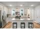 Bright kitchen with stainless steel appliances, countertops, island, and hanging lights at 305 Lanyard St, Johns Island, SC 29455