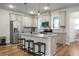 Bright kitchen with stainless steel appliances, countertops, island, and hanging lights at 305 Lanyard St, Johns Island, SC 29455