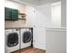 Convenient laundry room with modern washer and dryer units and stylish cabinetry at 305 Lanyard St, Johns Island, SC 29455