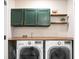 Well-equipped laundry room with a folding countertop, modern appliances, and charming decor at 305 Lanyard St, Johns Island, SC 29455
