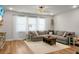 Bright living room featuring large sectional sofa, wood floors, and natural lighting at 305 Lanyard St, Johns Island, SC 29455