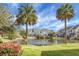 Picturesque pond surrounded by lush greenery, townhomes and clear blue sky at 305 Lanyard St, Johns Island, SC 29455