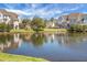 Picturesque pond surrounded by lush greenery and beautiful townhome exteriors at 305 Lanyard St, Johns Island, SC 29455