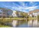 Picturesque pond surrounded by lush greenery and beautiful townhome exteriors at 305 Lanyard St, Johns Island, SC 29455