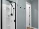 Modern white shower with black fixtures and a light blue wall at 305 Lanyard St, Johns Island, SC 29455