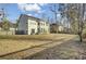 Large backyard with an expansive lawn, wooden fence, and patio set for relaxing at 314 Foxbank Plantation Blvd, Moncks Corner, SC 29461