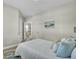 Relaxing bedroom offers a wrought iron bed, soft pillows, and a soothing wave painting, creating a calming coastal retreat at 314 Foxbank Plantation Blvd, Moncks Corner, SC 29461