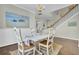 Bright dining room features a white table, four chairs, hardwood floors, and coastal decor at 314 Foxbank Plantation Blvd, Moncks Corner, SC 29461
