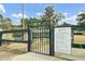 Dog park with secure metal gate, ensuring a safe space for pets to play, as well asposted rules at 314 Foxbank Plantation Blvd, Moncks Corner, SC 29461