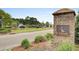 Community entrance to Foxbank Plantation with brick signage near a tranquil pond at 314 Foxbank Plantation Blvd, Moncks Corner, SC 29461