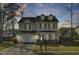 Charming two-story home boasts a welcoming front porch and well-maintained landscaping at sunset at 314 Foxbank Plantation Blvd, Moncks Corner, SC 29461