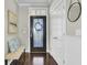 Stylish foyer with dark wood floors, a bench, and front door with glass detailing at 314 Foxbank Plantation Blvd, Moncks Corner, SC 29461