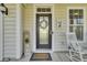 Cozy front porch with rocking chairs and a decorated front door at 314 Foxbank Plantation Blvd, Moncks Corner, SC 29461