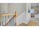 Carpeted stairway featuring a wooden banister and black iron balusters leading to the upper level of the home at 314 Foxbank Plantation Blvd, Moncks Corner, SC 29461