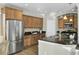 Kitchen boasts stainless steel appliances, granite countertops, tile flooring, and wooden cabinetry at 314 Foxbank Plantation Blvd, Moncks Corner, SC 29461